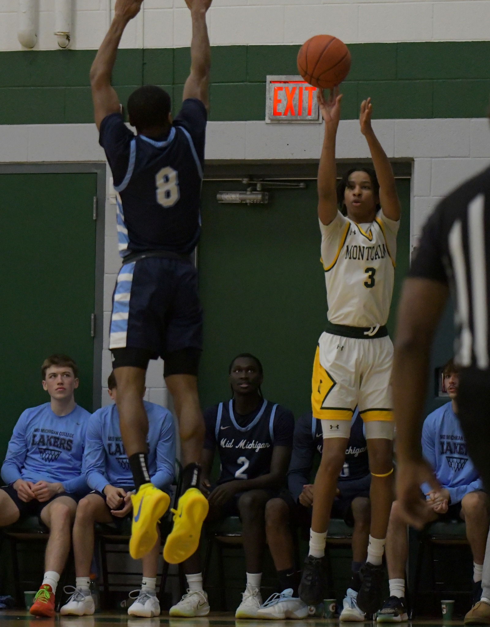 Men's basketball player shooting the ball during a game.