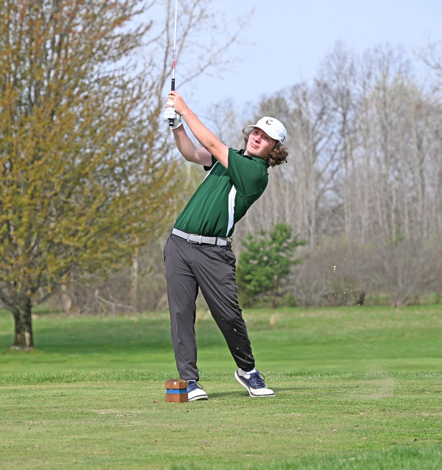 MCC Golfer Chase Couchman swinging a club on the golf course.