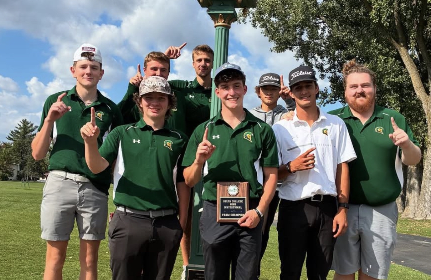 MCC men's golf team holding up their first place plaque at the Delta Invitational.