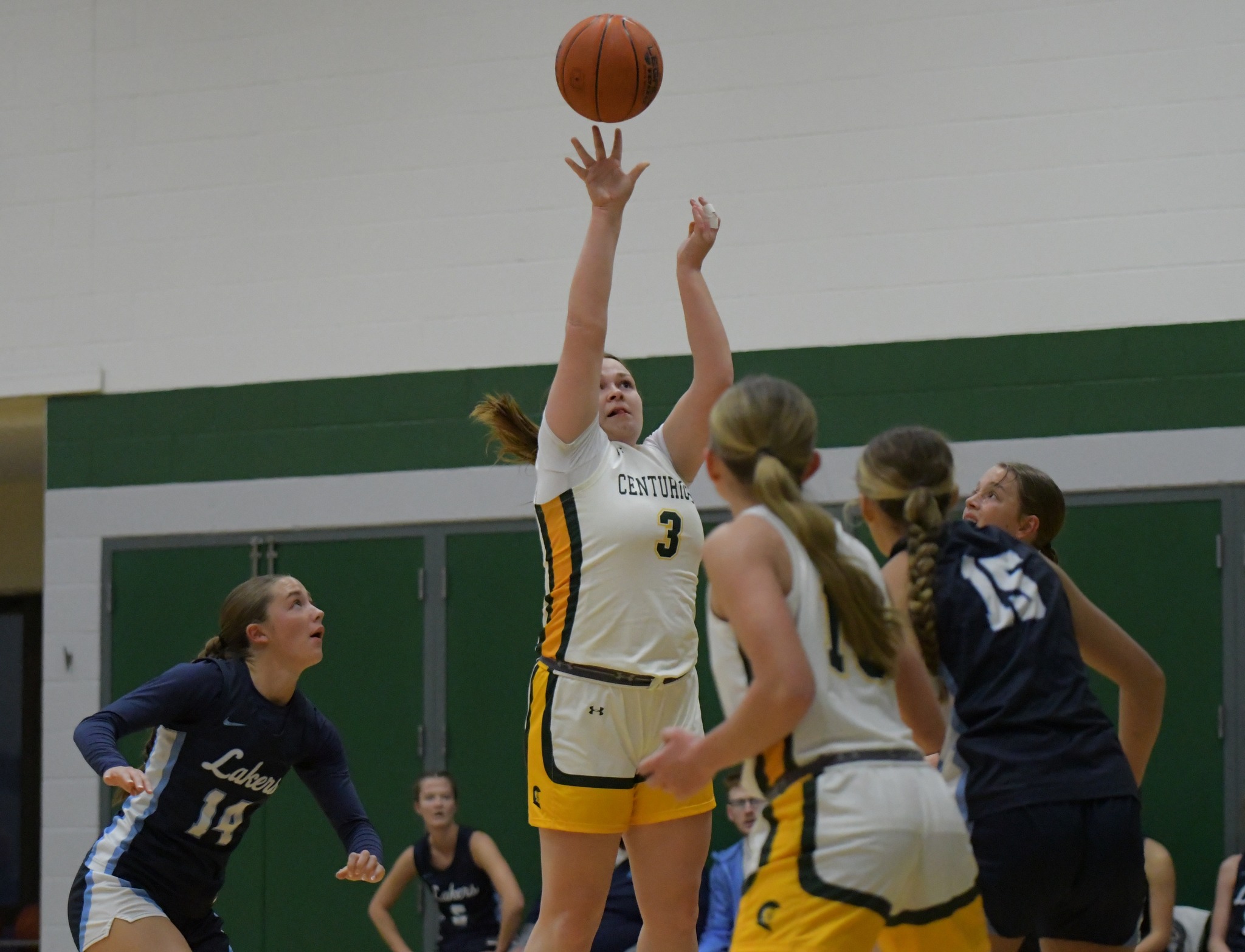 MCC women's basketball player shooting the ball.