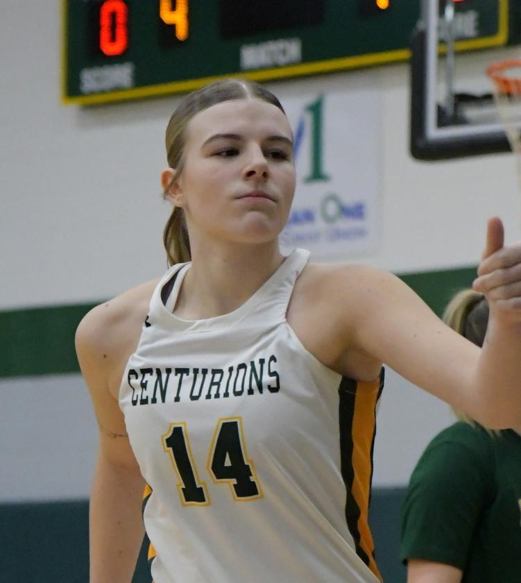 MCC women's basketball player running on the court during a game. Her jersey number is 14.