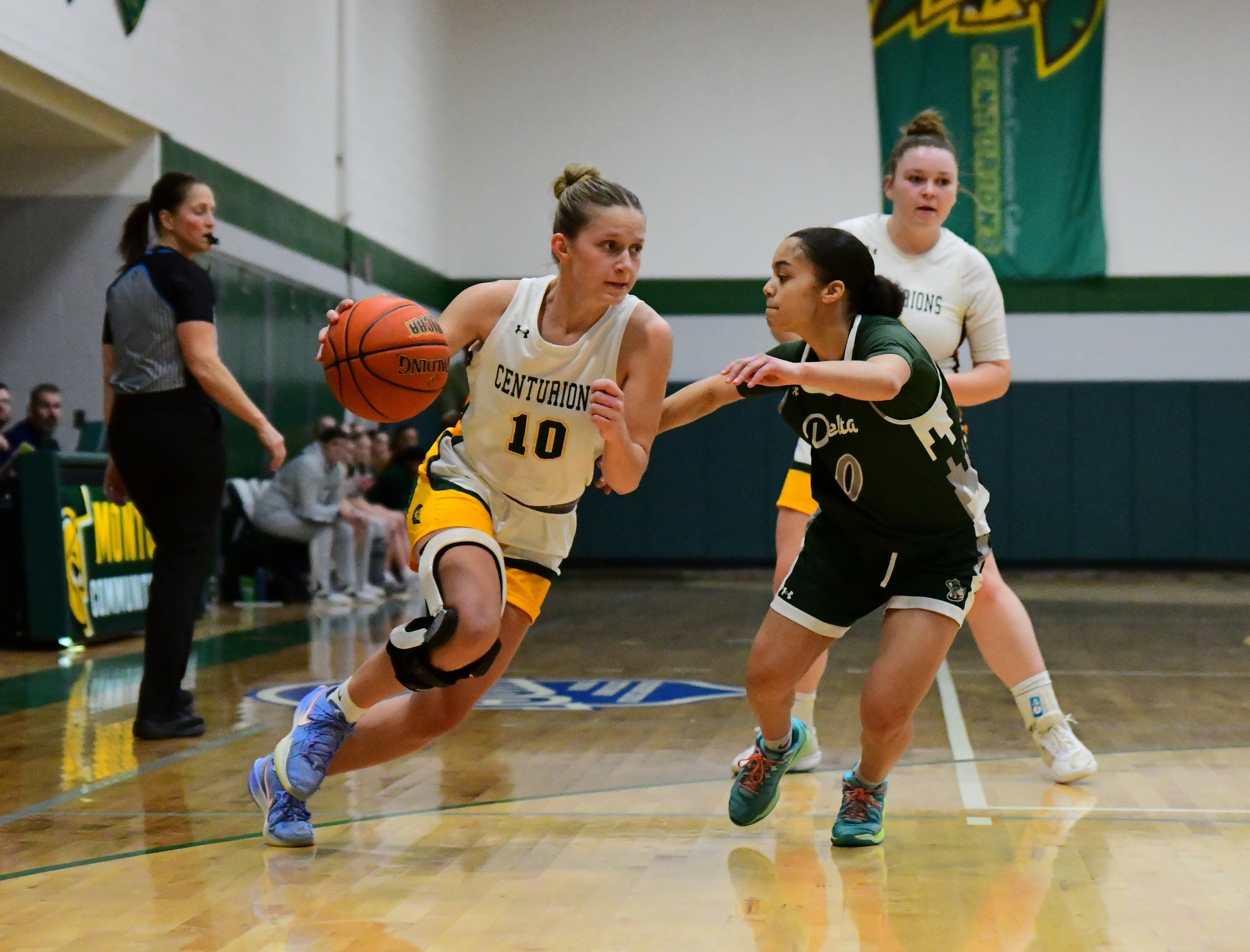 Baylor Syrjala dribbling the basketball down the court.