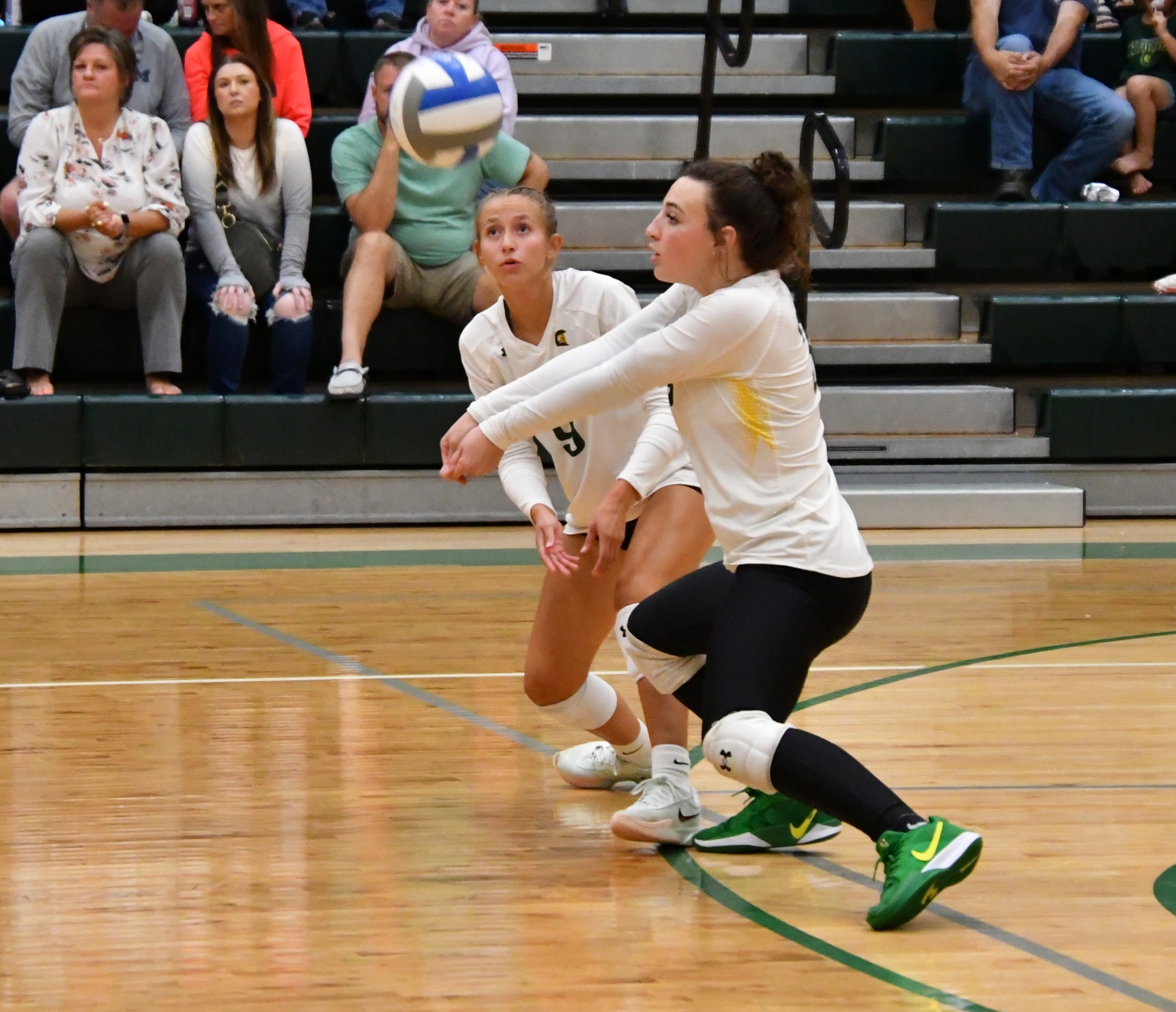 MCC Volleyball player bumping the ball on the court.